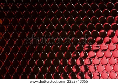 Abstract modern futuristic trendy silver circles pattern background texture reflecting red light