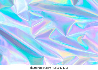 Abstract Modern Pastel Colored Holographic Background In 80s Style. Crumpled Iridescent Foil Textile Real Texture. Synthwave. Vaporwave Style. Retrowave, Retro Futurism, Webpunk