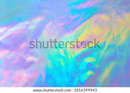  Abstract Modern pastel colored holographic background in 80s style. Crumpled iridescent foil textile real texture. 