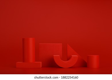 Abstract monochromatic still life in red colors with different geometric figures on red background with space for text