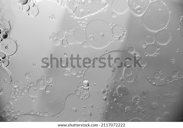 Abstract\
moon background circles and oil stains on\
water