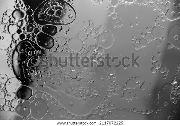 Abstract\
moon background circles and oil stains on\
water