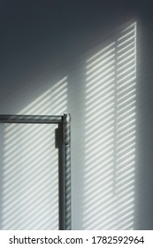 Abstract Of Morning Light And Shadow On Wall Through Window Blind Shutter.  Light Through Blinds Window. Parallel Lines Of Light And Reflection Provide