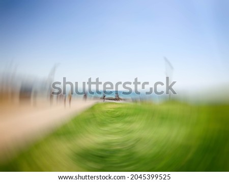 Similar – zwei erwachsene und ein kind in badebekleidung auf einem roller am meer. verschwommen