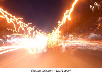 Abstract Motion speed, Light Tai background with blurred magic neon light curved lines. Lights and stripes moving fast over dark background. Orange backdrop from fast moving glow particles.
