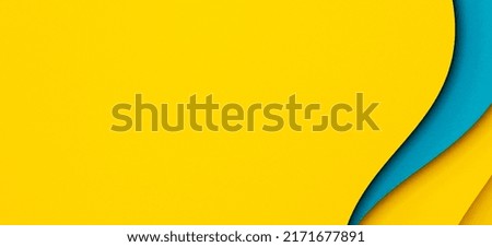 Abstract multicolored papers geometry flat lay composition banner background. Waved shaped blue, yellow color lines background. Top view, copy space