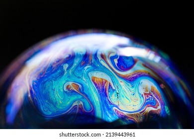 Abstract multicolored pattern, chaotic texture inside of the soap bubble, closeup. High quality FullHD footage.