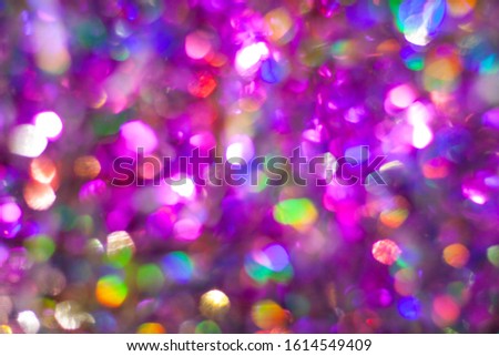 Abstract multicolored purple rainbow background. Defocused light holographic tinsel with bokeh effect.