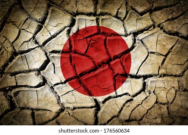 Abstract Natural Background With Cracked Earth Texture And Japan Flag On It. Symbol Of Earthquake