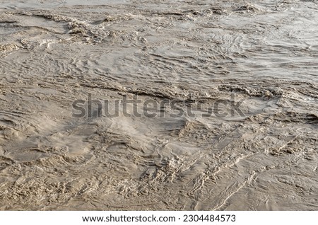 Abstract natural background of muddy turbulent water
