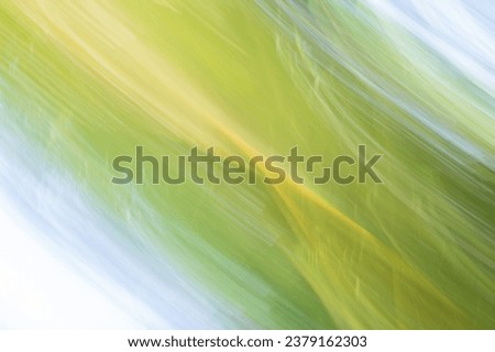 Abstract nature blur green diagonal pattern using intentional camera movement background.