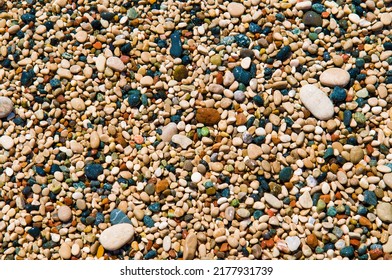 Abstract nature pebbles background. Multicolored wet pebbles on the Mediterranean beach. - Shutterstock ID 2177931739
