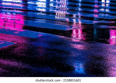 Abstract Neon light reflection at nightlife district from wet street with vehicle traffic and pedestrian walking by. Nightlife, futuristic metaverse city, and cyberpunk concept. - Powered by Shutterstock