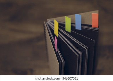 Abstract notebook with color note tab. Notebook with colors note tab on wooden table background, Vintage picture tone.
 - Shutterstock ID 546307051