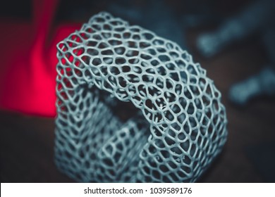Abstract object of a gray color printed on a 3d printer on black dark surface. Fused deposition modeling, FDM. Progressive modern additive technology. Concept of 4.0 industrial revolution