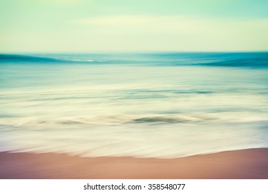 An abstract ocean seascape with blurred panning motion.  Image displays a retro, vintage look with cross-processed colors.