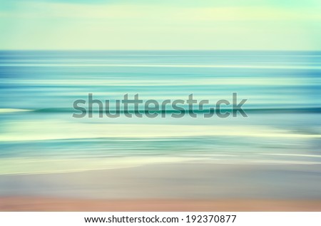 An abstract ocean seascape with blurred panning motion.  Image displays a retro, vintage look with cross-processed colors.