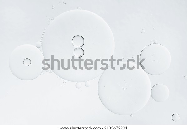 Abstract oil bubbles background. Cosmetic liquid\
beauty product. Face serum\
texture.
