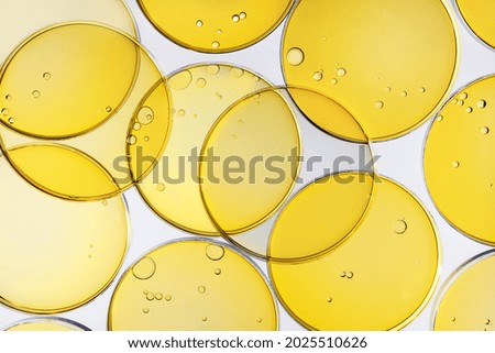 Abstract oil circle bubbles in a petri dish top view. Laboratory cosmetic or medicine background.