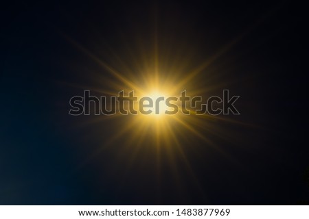 Abstract orange and blue sparkling light rays and lighting flare bokeh against on dark blue sky background