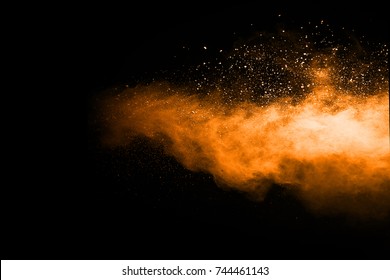 Abstract Orange Powder Splatted Background,Freeze Motion Of Color Powder Exploding/throwing Color Powder,color Glitter Texture On Black Background.