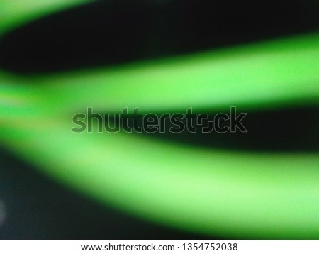 Abstract out of focus Green lights coming from the mother nature with abstract background of Black color. Abstract background of Green and black color. 