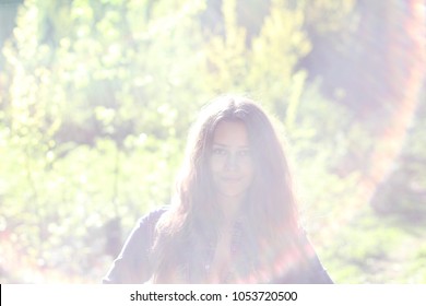 
Abstract Overexposed Portrait Of A Girl In A Backlight In A Forest.