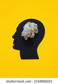 Abstract Overthinking Man  Simple Composition and Simple Black Human Head   White Crumpled Piece Paper Yellow Background  Brain Made Creased Paper 