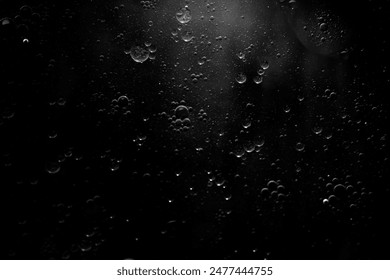 Abstract oxygen bubbles in the sea.Air bubbles in the water background.Water bubbles isolate on black background.Black and white tone style. - Powered by Shutterstock