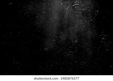 Abstract oxygen bubbles in the sea.Air bubbles in the water background.Water bubbles isolate on black background.Black and white tone style. - Powered by Shutterstock