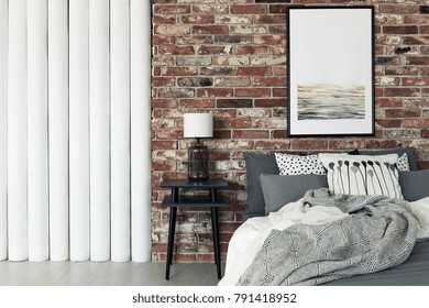 Abstract Painting Hanging On A Brick Wall In A Flat Interior