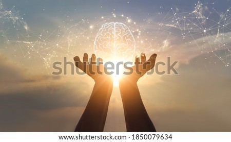 Abstract palm hands holding brain with network connections, innovative technology in science and communication concept