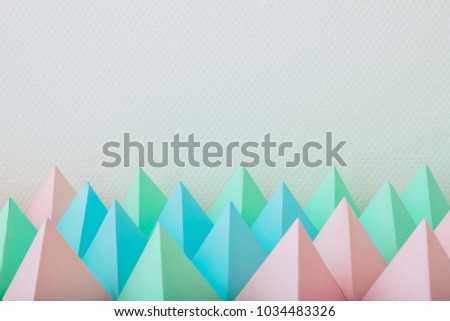 Abstract paper pyramids pattern in the shape of nature landscape and mountains.design by paper art and digital craft style. Minimal futuristic concept.