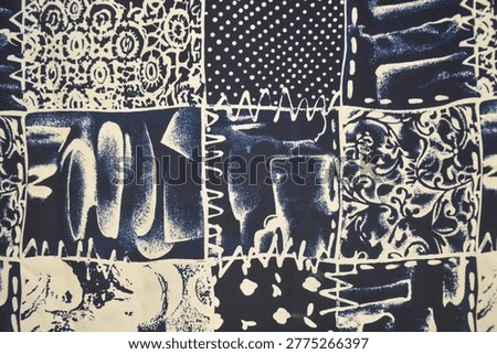 Abstract patchwork textile pattern in navy blue and off-white. Close up of fabric texture with polka dots, floral ornaments, and batik motifs for vintage background.