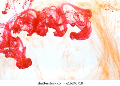 Abstract pattern falling into the water drop of yellow and red ink