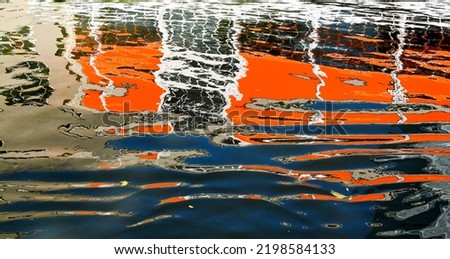 Abstract pattern formed by the reflection. of a building on the rippled water of a canal
