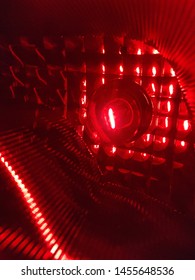 Abstract pattern inside red light bulb and reflecting mirror.