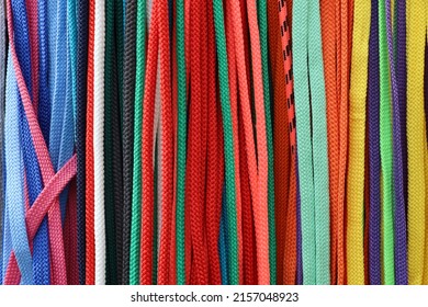 Abstract Pattern. Multicolored Bright Shoelaces Are Tightly Arranged In Vertical Rows. Front View