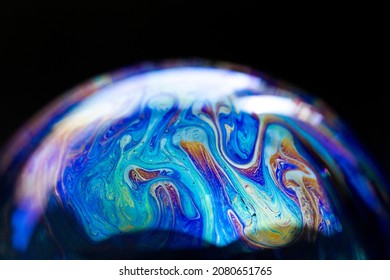 Abstract pattern, multicolored chaotic texture inside of the soap bubble, closeup