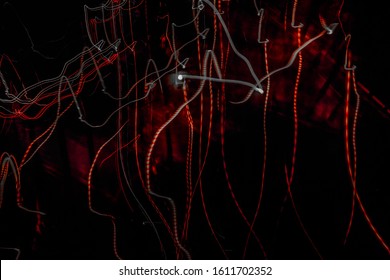 Abstract pattern with red and gray crooked lines on black background