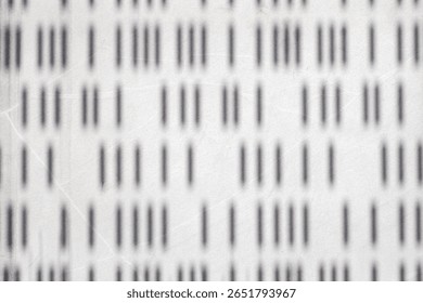 Abstract pattern of vertical lines on white surface.