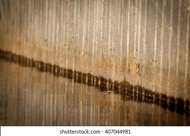 Abstract Pattern Of Wall Reflected In Water