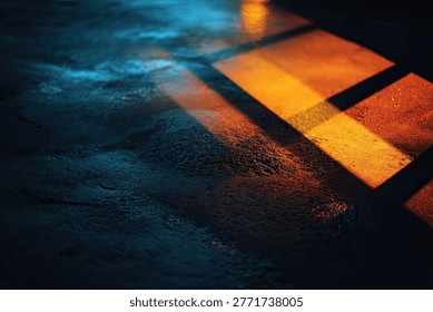 Abstract pattern of warm orange and cool blue light reflections on a dark, textured surface, creating a moody and atmospheric effect.