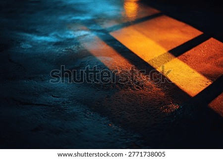 Abstract pattern of warm orange and cool blue light reflections on a dark, textured surface, creating a moody and atmospheric effect.