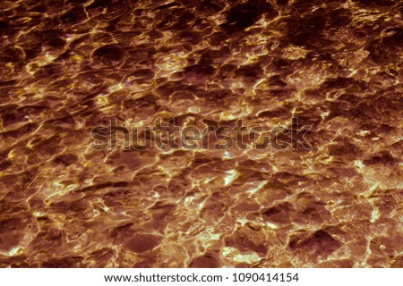 Abstract patterned gold surface water in the pool.