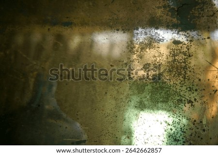 Abstract patterns and reflections on the surface of a dirty mirror                              