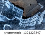 Abstract patterns and shapes in thin ice of the Hockanum River in Vernon, Connecticut, in winter.