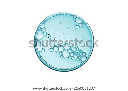 Abstract petri dish with cosmetic or medical liquid isolated on white background top view. Science cosmetic laboratory concept.