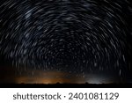 Abstract photo of Blue Night sky star trail background.Startrails on a dark blue sky at night,center sky area.Rotating star lines. The North Star and meteor showers.