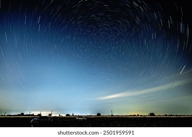 Abstract photo of Blue Night sky star trail background.Startrails on a dark blue sky at night,center sky area.Rotating star lines. The North Star and meteor showers.